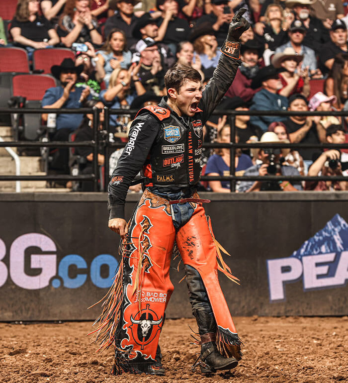 KC Outlaws rider celebrating a score during a Professional Bull Riders Team Series event.