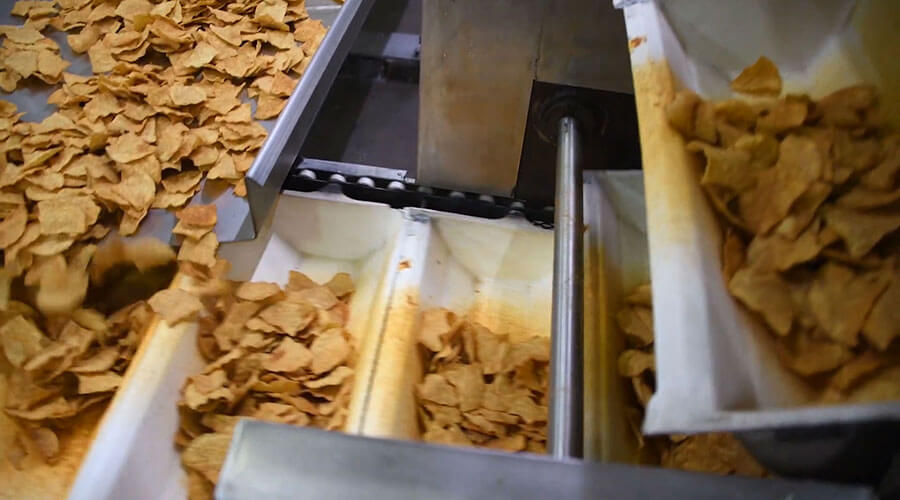 Outlaw Snax tortilla chips moving through the production line at the Ocala, Florida snack manufacturing facility.